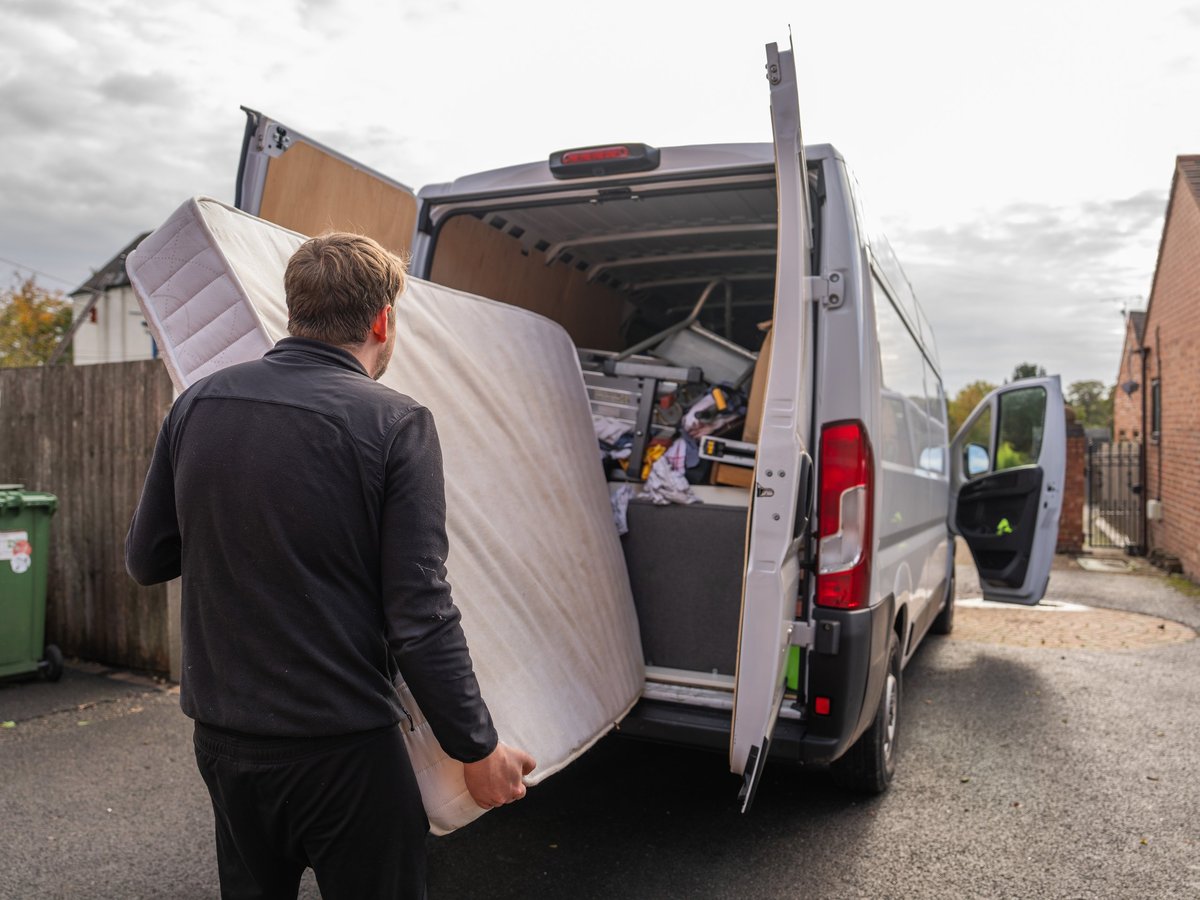 Loading a mattress into a removal van during a furniture removal job
